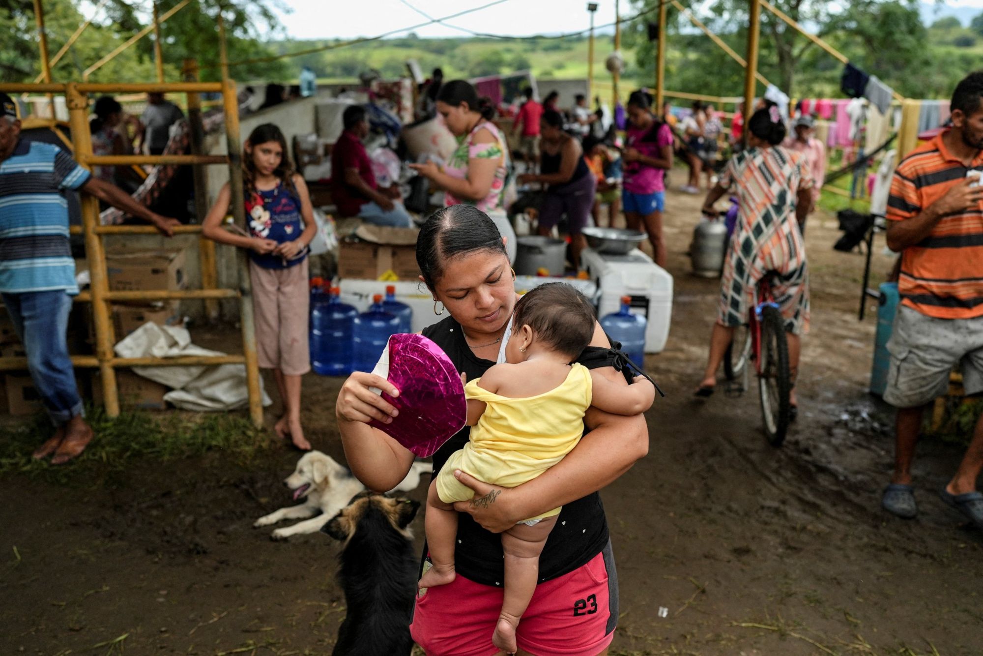 A mother holds her baby at a makeshift camp where families are sleeping outside after the earthquake.